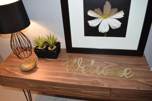 uma mesa de madeira com uma fotografia e um sinal de boas-vindas em Casa Lisboa Oriente em Lisboa