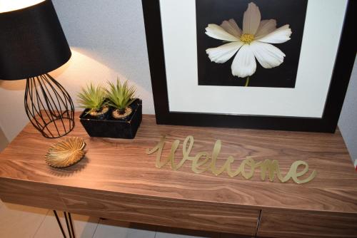 a wooden table with a picture and a welcome sign on it at Casa Lisboa Oriente in Lisbon