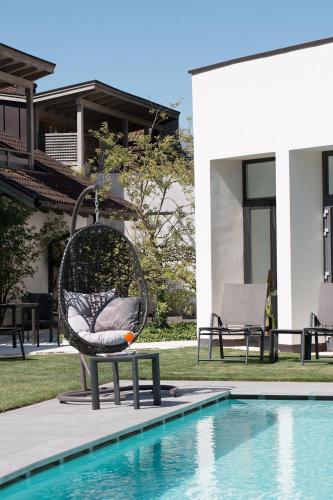 a chair sitting next to a swimming pool at Botango in Parcines