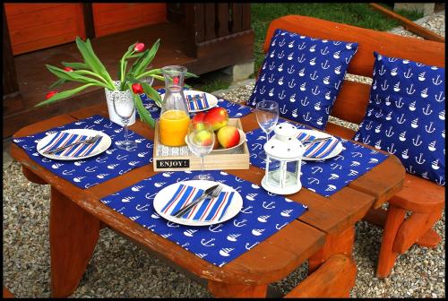 a table with plates of food and fruit on it at PRZYSTAŃ CISZY in Jantar