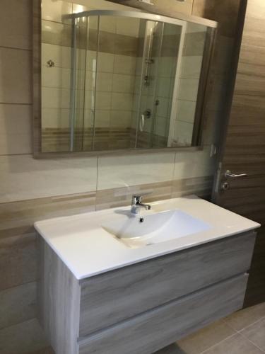 a bathroom with a white sink and a mirror at B&B Nonna Maria in Lamezia Terme