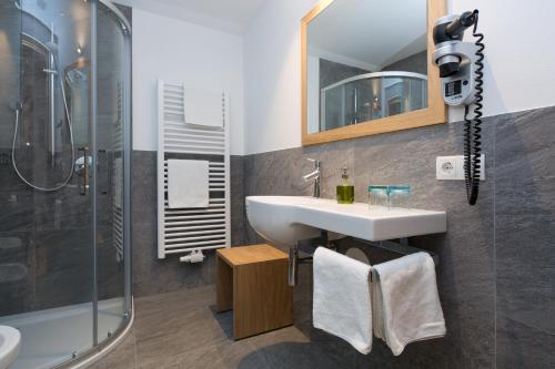 a bathroom with a sink and a shower at Garni Bachlerhof in Brunico