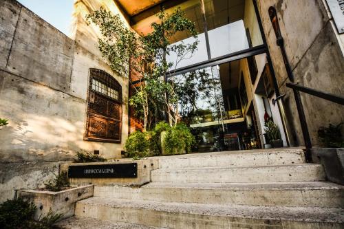 a building with stairs in front of a store at Alfonsina Hotel Boutique in Santa Cruz de la Sierra
