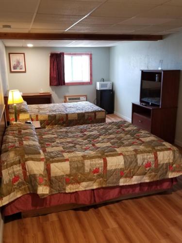 Кровать или кровати в номере Wolds Motel - Mt. Pleasant