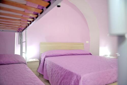 A bed or beds in a room at casa vacanze"IL TRAMONTO"