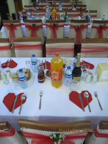 a table with plates of food and drinks on it at Ayvazali Hotel in Bergama