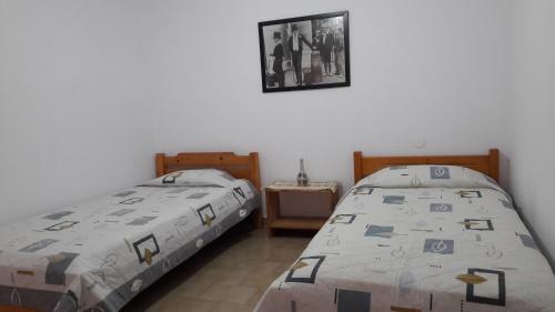 two beds sitting next to each other in a bedroom at Anastasia' s guest house in Neos Marmaras