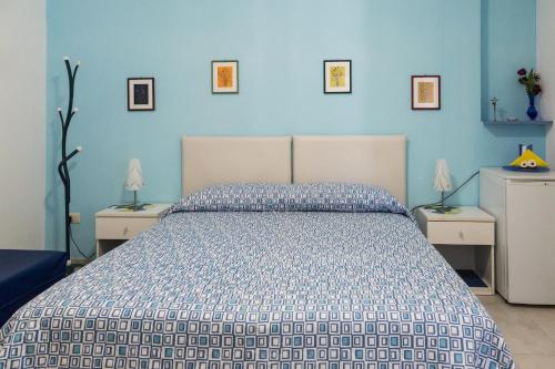a bedroom with a bed with a blue wall at Aurora Sul Mare in Otranto