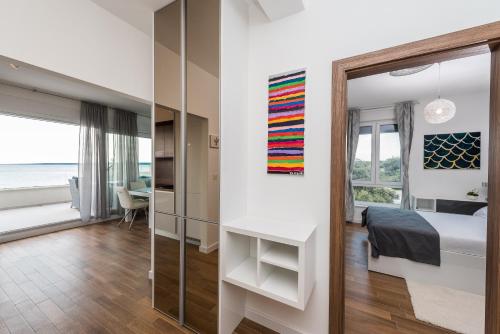 a bedroom with a bed and a glass wall at Luxury penthouse in Mandre