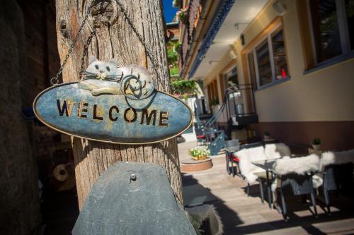 a welcome sign on the side of a building at Hotel Excelsior in Zermatt
