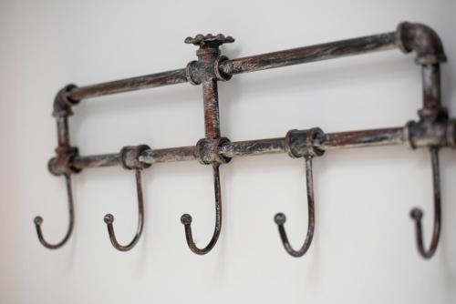 a group of rusty pipes hanging on a wall at Lyon Mon Amour B&B in Lyon