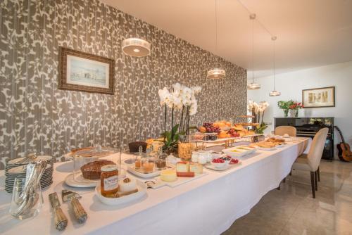 a buffet table with a lot of food on it at Cascais Casa Laranja Guesthouse in Cascais