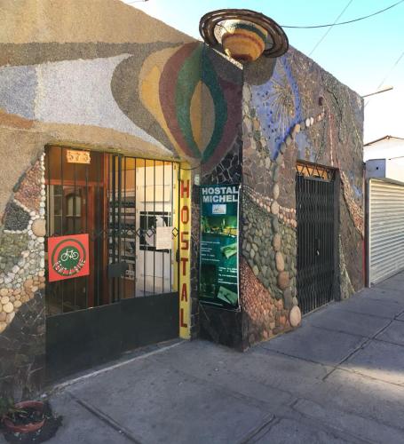 a building with a mural on the side of it at Hostal Michel in Vicuña