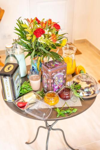 a table with a vase of flowers on it at Lyon Mon Amour B&B in Lyon