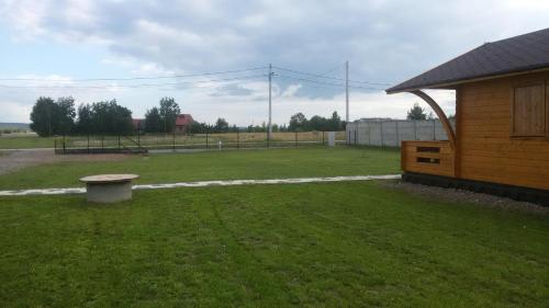 a park with a bench in the middle of a yard at Witówka Bieliny in Bieliny
