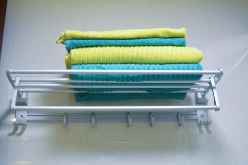 a group of four towels on a shelf at Lan House Youth Apartment in Guangzhou