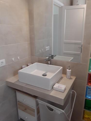 a bathroom with a white sink and a mirror at Le farniente in Costa Teguise