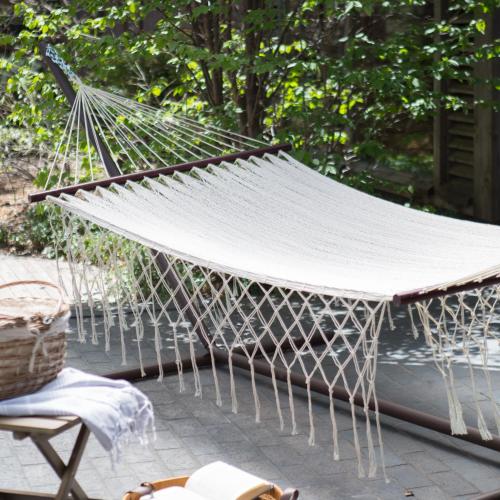 a hammock on a patio with a row of chairs at Cancun Blue Airport in Cancún