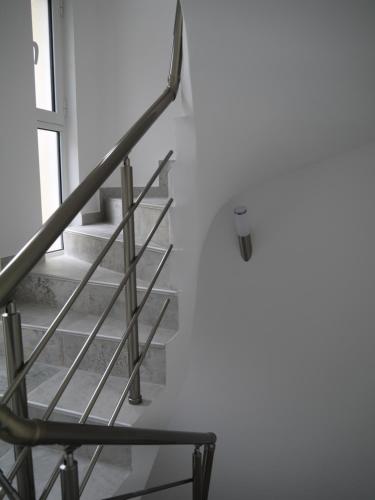 a staircase in a white room with a window at CrystalSky in Dobra Voda