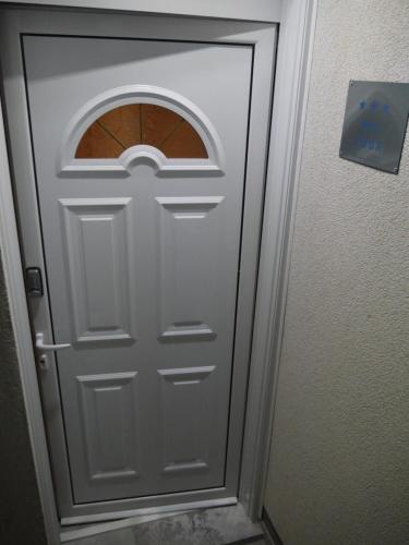 a white door with a window in a room at CrystalSky in Dobra Voda