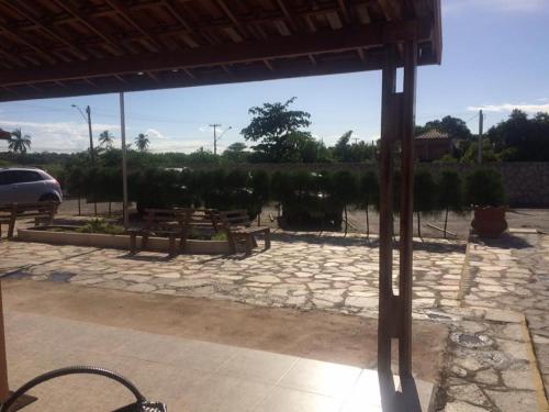 a stone patio with a car parked in a yard at Hotel Mirante do Vale in Itabaiana