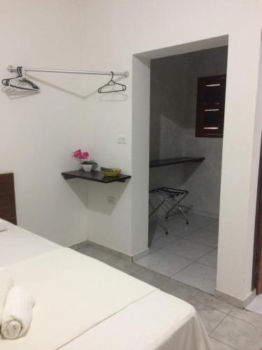 a bedroom with a bed and a table and a staircase at Hotel Mirante do Vale in Itabaiana