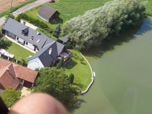 an overhead view of a house next to a river at Chalupa u rybníka Střehom in Dolní Bousov
