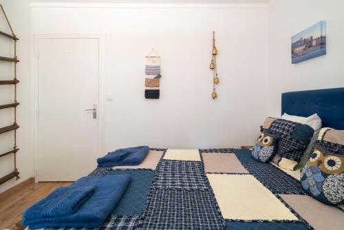 a bedroom with a bed with a blue headboard at Lyon Mon Amour B&B in Lyon