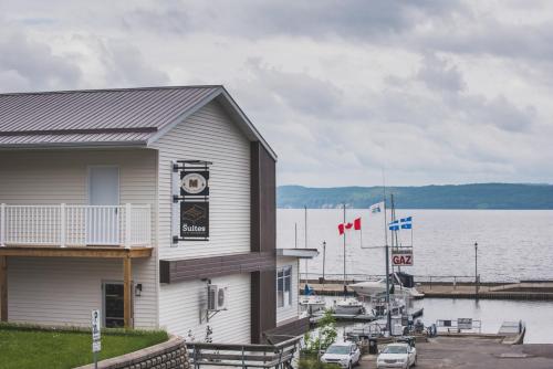 a building with a marina next to a body of water at Les suites de la chocolaterie in Ville-Marie