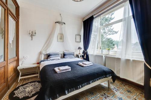 a bedroom with a bed with two towels on it at Chesterfield appartement -view on garden in Durbuy