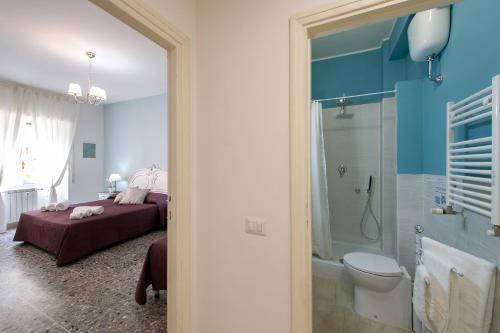 a bedroom with a bed and a shower and a toilet at House Bonifacio in Rome