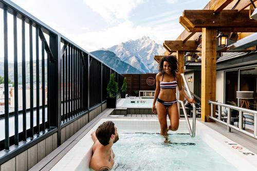 a woman in a bikini standing in a swimming pool at Mount Royal Hotel in Banff