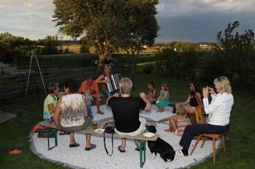 a group of people sitting in a circle playing music at Familienbauernhof Strassbauer in Steinakirchen am Forst