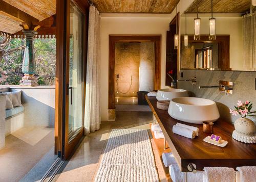 a bathroom with two sinks and a large mirror at Kahani Paradise in Gokarna