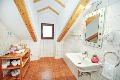 a bathroom with a sink and a mirror at Seafront Apartment 2 in Cavtat