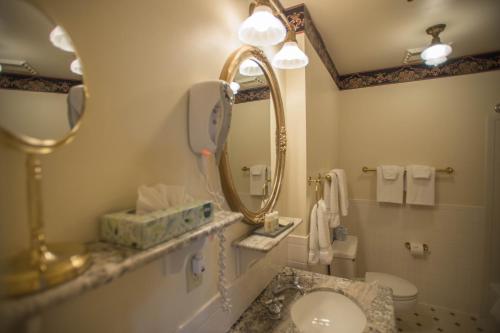 a bathroom with a sink and a mirror and a toilet at Hotel Boulderado in Boulder