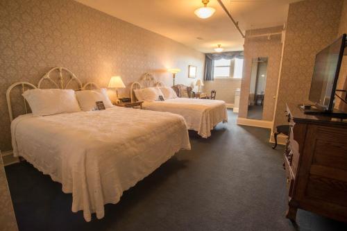 a hotel room with two beds and a television at Hotel Boulderado in Boulder