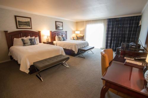 a hotel room with two beds and a piano at Hotel Boulderado in Boulder