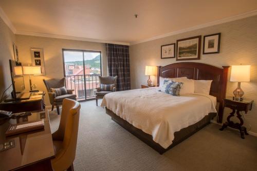 a hotel room with a bed and a balcony at Hotel Boulderado in Boulder