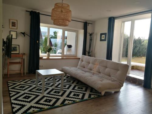 a living room with a couch and a table on a rug at Dru-Sky in Druskininkai