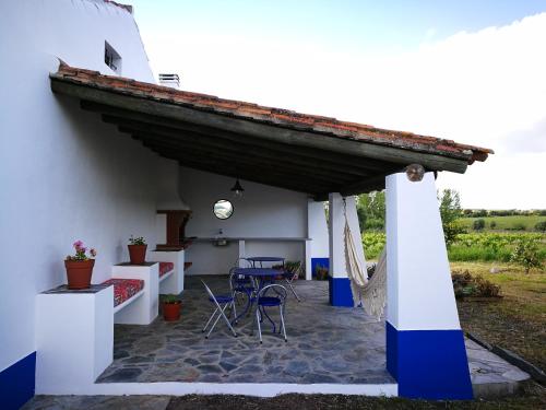 a patio of a house with a table and chairs at Monte dos Velhos in Reguengos de Monsaraz