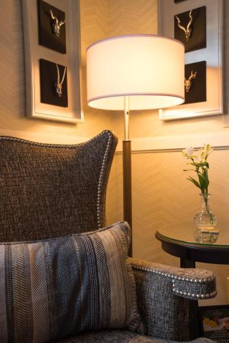 a lamp in a room with a couch and a table at Hotel Boulderado in Boulder