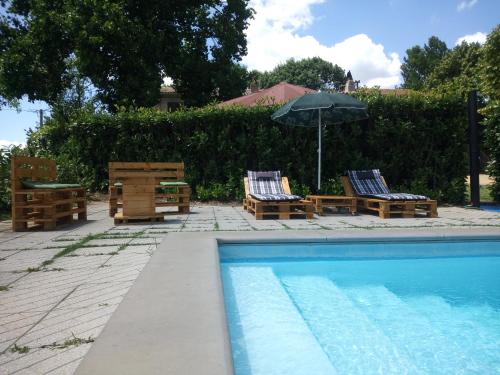 a swimming pool with lounge chairs and an umbrella at Agriturismo Podernuovo in Acquapendente