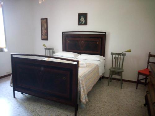 a bedroom with a large bed and a chair at Agriturismo Podernuovo in Acquapendente
