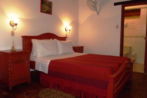 a hotel room with a bed and a mirror at Hotel Mision Santa Barbara RNT 4799 in Barichara