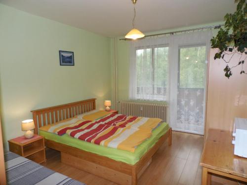 A bed or beds in a room at Apartmán Zdravie Horný Smokovec
