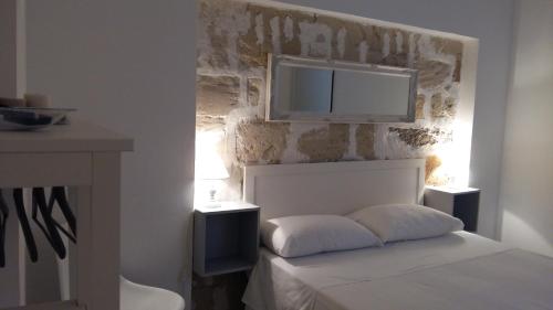 Tempat tidur dalam kamar di Appartamenti e Camere Silva Trapani