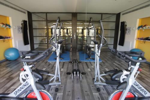 a gym with three treadmills and exercise bikes at Three O Nine Hotel in Beirut