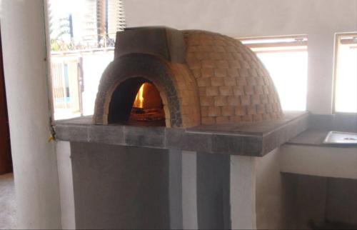 a brick oven in a room with a window at Casa de las Olas Surf & Beach Club in Acapulco