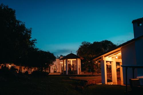 a house with a gazebo at night at El Pueblito Hotel Boutique in Samaipata